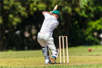 A batsman swinging and missing the ball