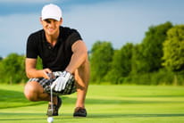 A golf player studying the next shot