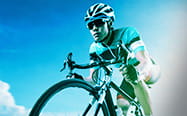 A close up of a cyclist with the sky in the background