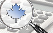 A calculator with a magnyifying glass showing a Maple leaf