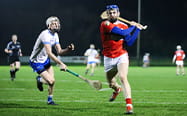 Two hurling players in a game
