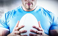 A rugby player holding the ball