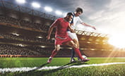 Two men playing football in a stadium