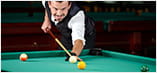 A snooker player lines up to take a shot