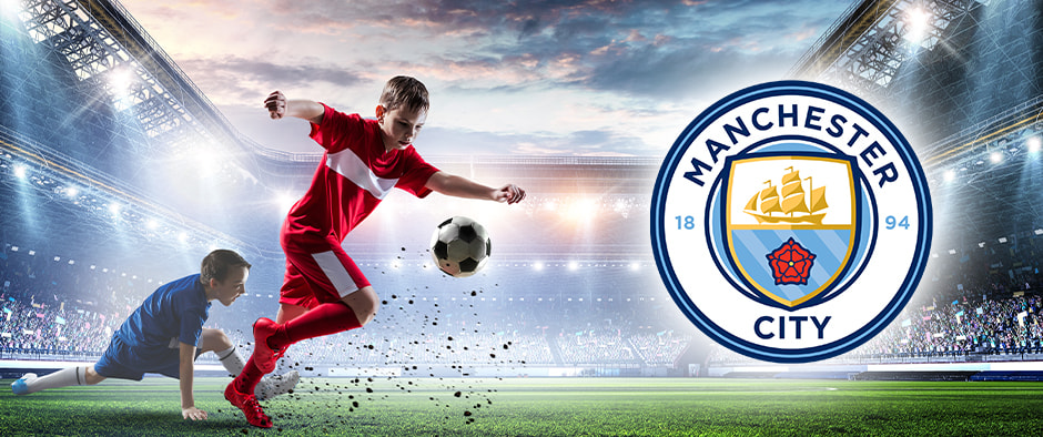 Children playing on a football field and the Manchester City logo.