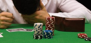 Person, losing a game on a blackjack table.