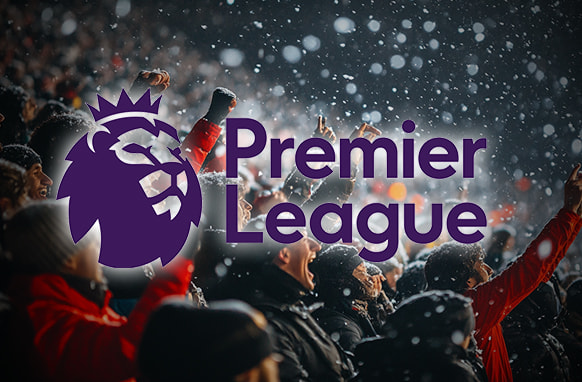 Fans cheering in a snow-filled stadium with the Premier League logo prominently displayed in the foreground