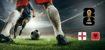 An image showing a close-up of two football players in action on the pitch, with one preparing to kick the ball. The FIFA World Cup 2026 logo is prominently displayed above, alongside the national flags of England and Albania, set against a dramatic stadium backdrop under moody lighting.