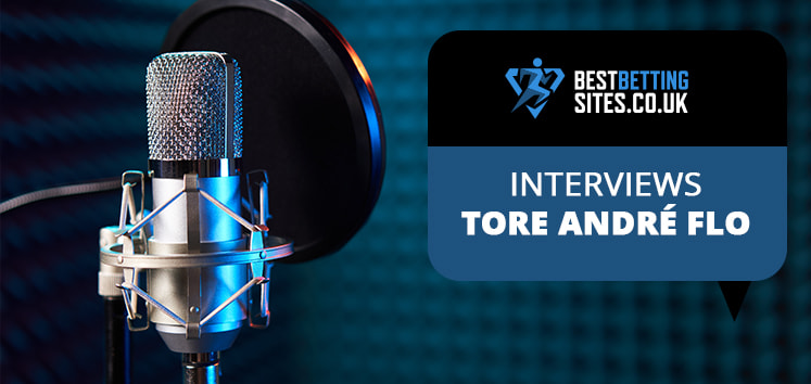 Close-up of a professional podcast microphone with a pop filter, set against a soundproof studio background. A speech bubble reads “Interviews – Tore André Flo” with the BestBettingSites.co.uk logo.