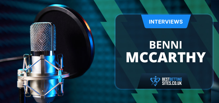 The image features the setup for an interview. On the left is a professional microphone with a pop filter, indicating a recording environment. On the right side of the image is a text box with the word "INTERVIEWS" written at the top in a blue banner. Below it, the name "BENNI MCCARTHY" is prominently displayed. The website "BESTBETTINGSITES.CO.UK" is mentioned at the bottom of the text box. The background is filled with a blue and green geometric pattern, giving a professional and modern appearance.